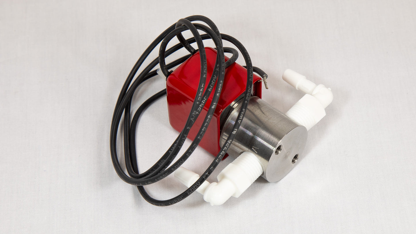 A red and white valve with a power wire attached, positioned against a neutral background.