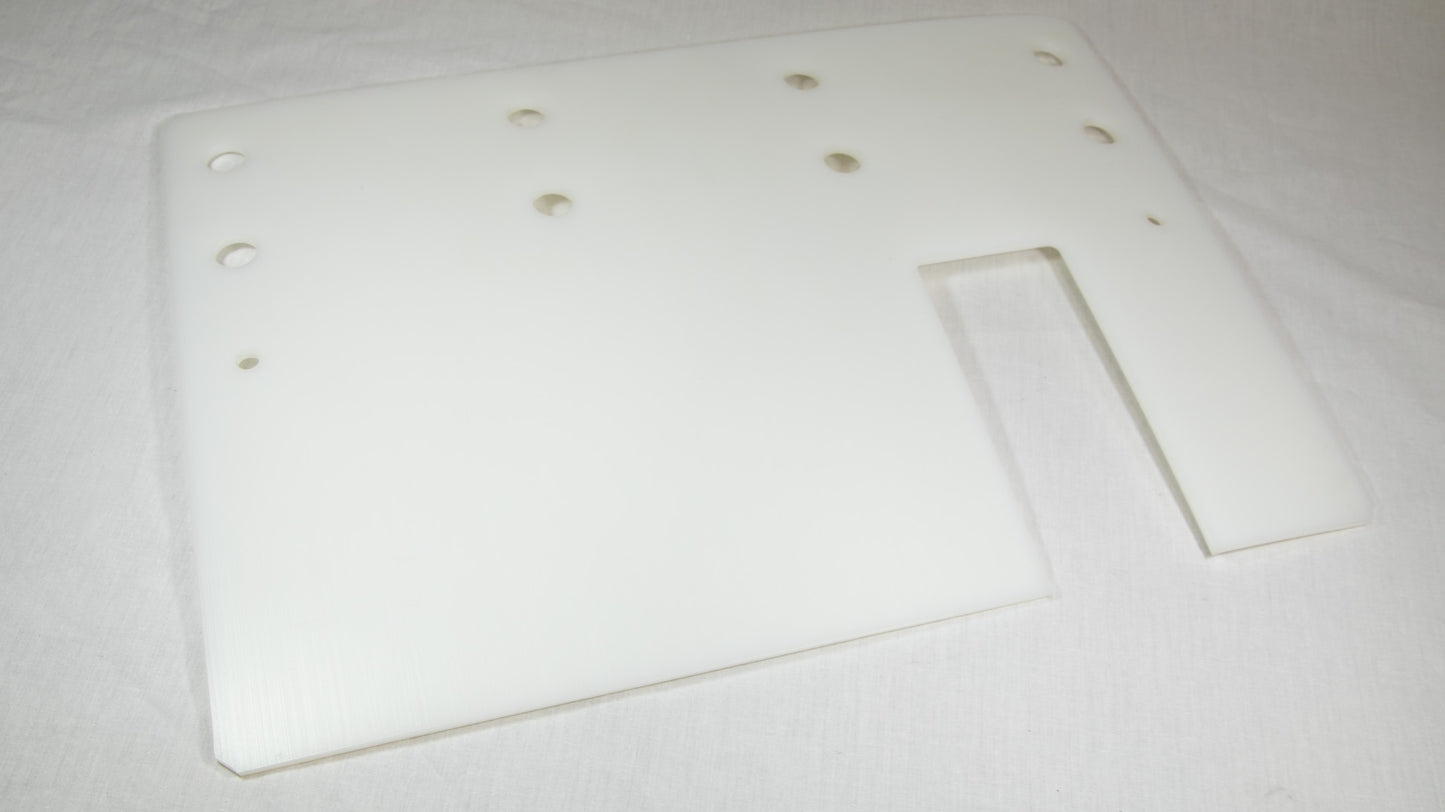 A white plastic plate featuring multiple holes evenly distributed across its surface.