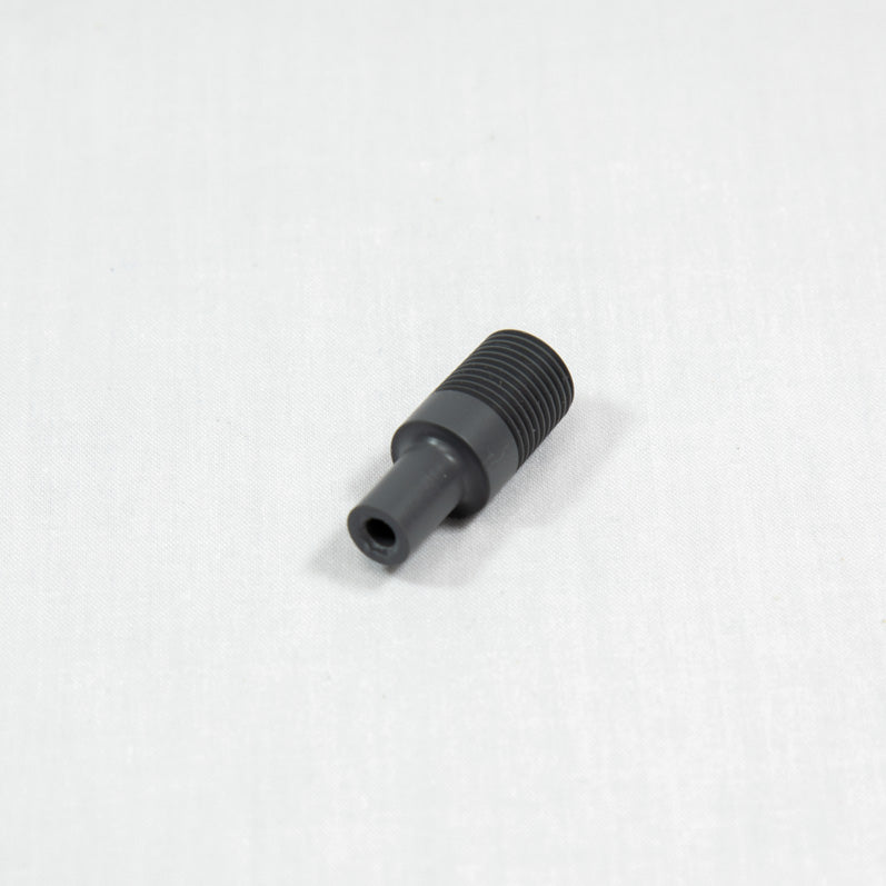 A black plastic threaded nut resting on a white surface, showcasing its circular shape and detailed threading.