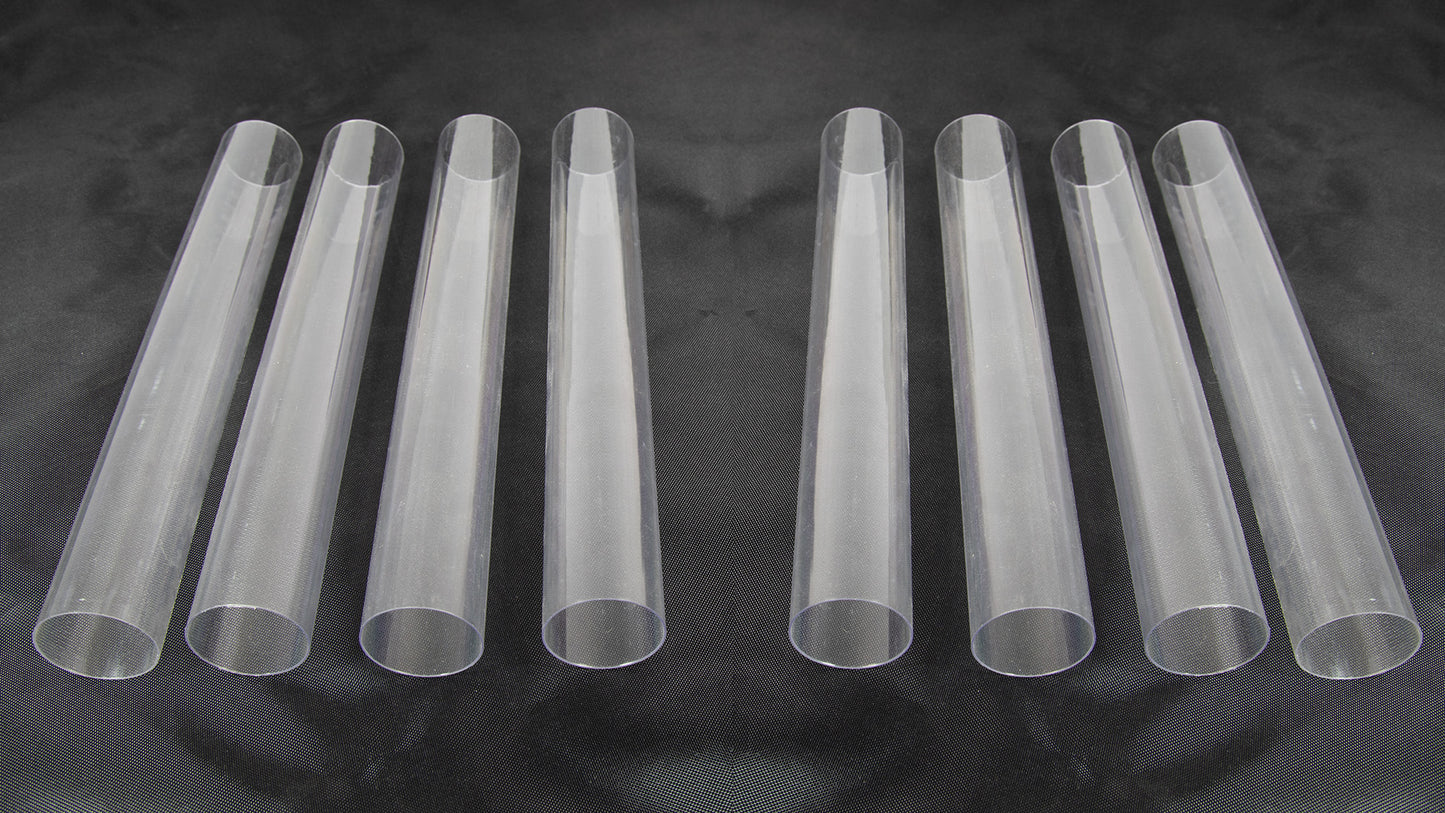 Eight clear plastic tubes of varying sizes arranged together on a neutral background.