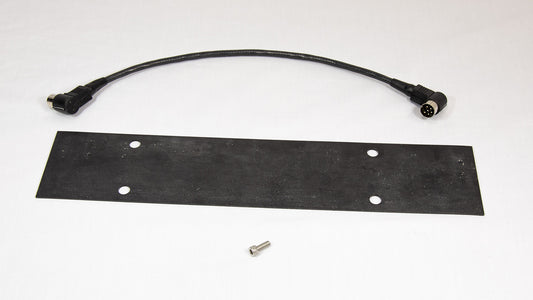 A black plastic plate accompanied by one screw and a cord, positioned on a simple surface.