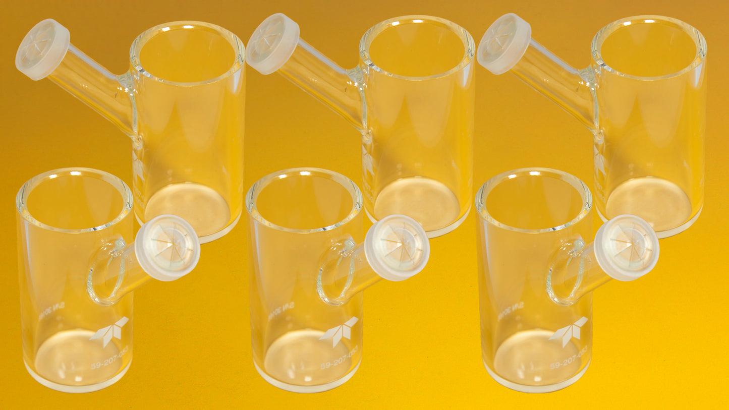 Six glass tubes arranged against a bright yellow background, showcasing their transparent structure and varying heights.