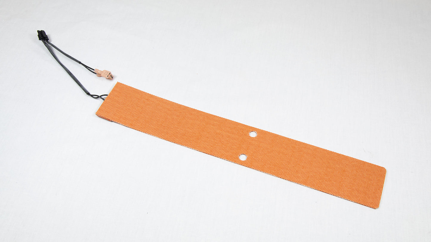 A small orange pad with a wire attached, indicating a functional use in a project.