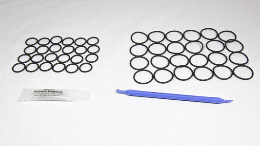 Various rubber o-rings displayed alongside a plastic tube, highlighting their flexibility and vibrant colors.