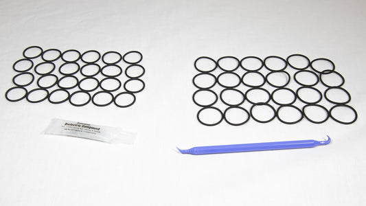 Various rubber o-rings displayed alongside a plastic tube, highlighting their flexibility and vibrant colors.