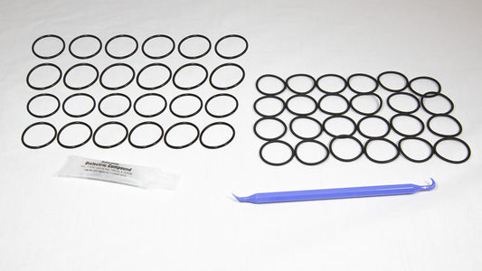 Various rubber o-rings displayed alongside a plastic tube, highlighting their flexibility and vibrant colors.