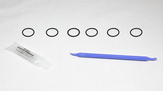 Various rubber o-rings displayed alongside a plastic tube, highlighting their flexibility and vibrant colors.