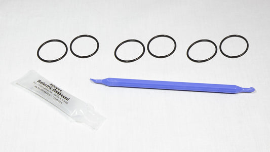 Various rubber o-rings displayed alongside a plastic tube, highlighting their flexibility and vibrant colors.