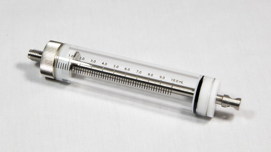 A transparent glass cylinder connected to a metal tube, representing a basic yet effective structural element.