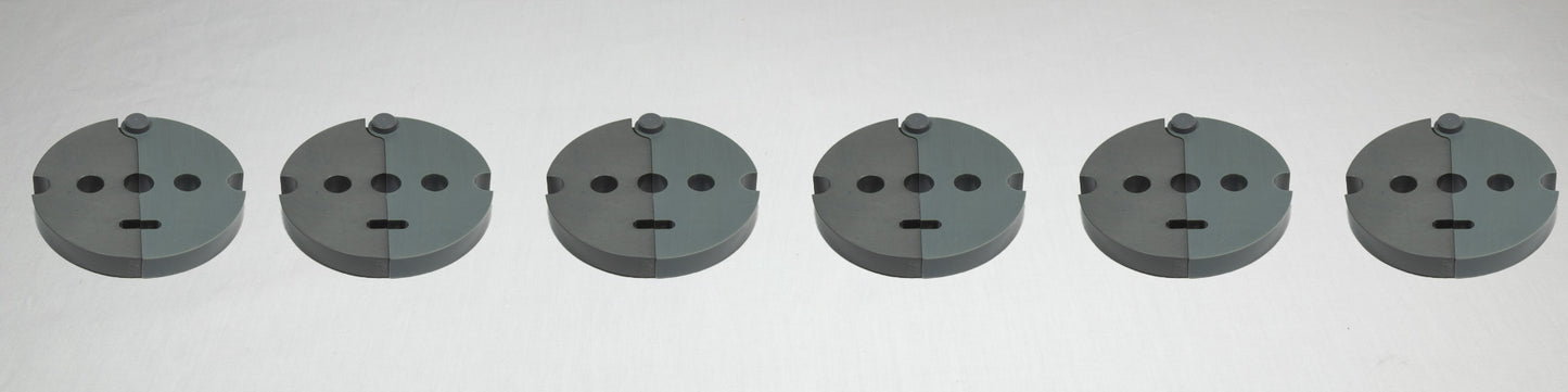 A collection of six gray plastic plates, each with holes and screws, displayed together on a plain background.