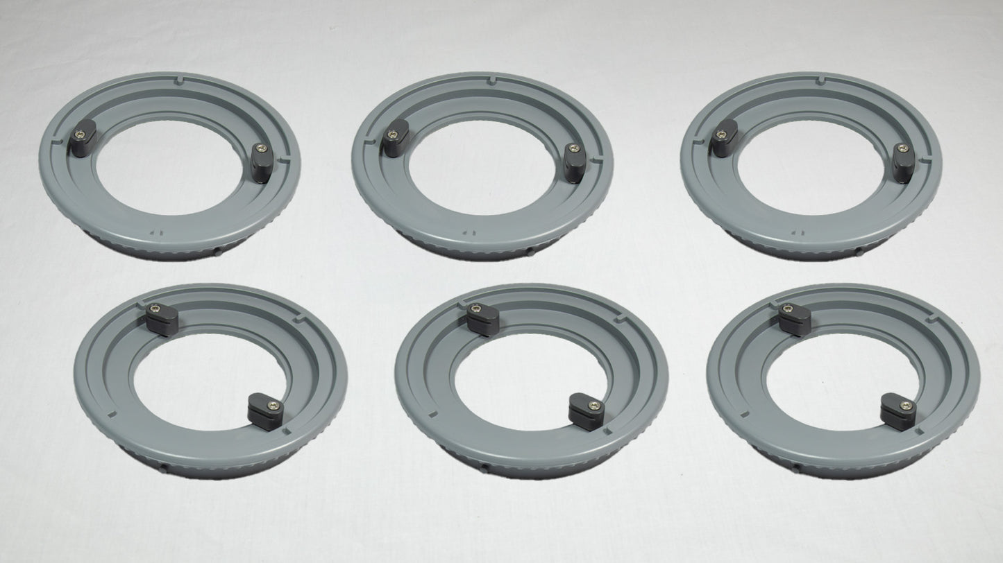 Six gray plastic rings arranged on a white surface, showcasing their circular shape and smooth texture.