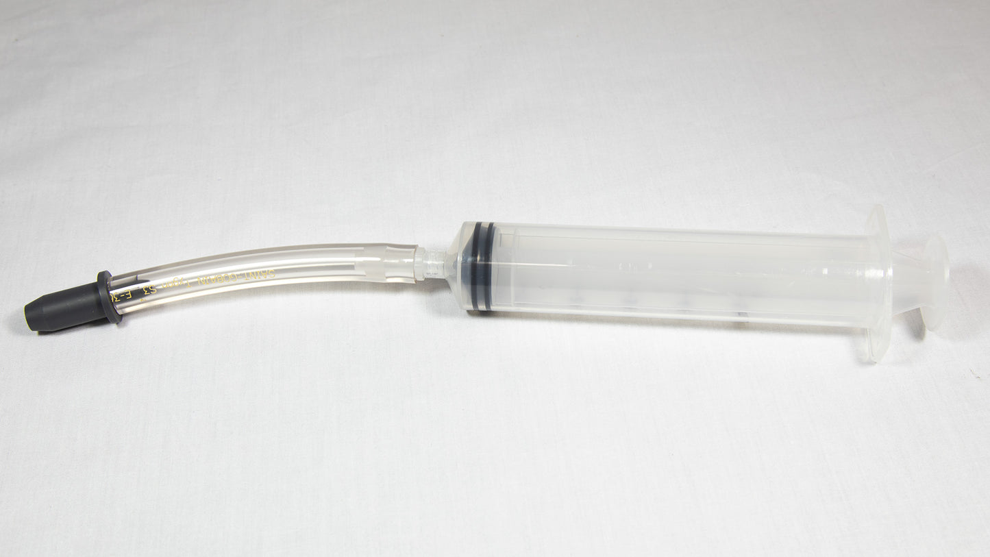 A syringe equipped with a needle and tube, commonly used in medical procedures for fluid transfer.
