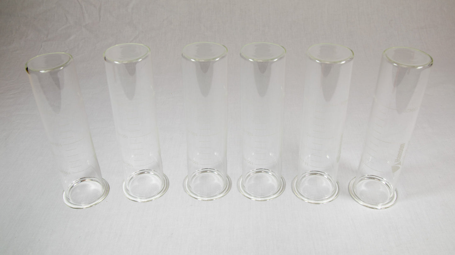Six clear plastic containers with lids arranged neatly on a bright yellow background.