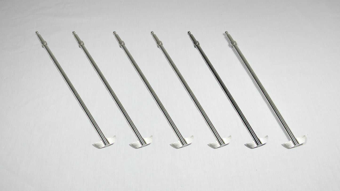 Six stainless steel rods arranged neatly on a white surface, showcasing their sleek and shiny appearance.