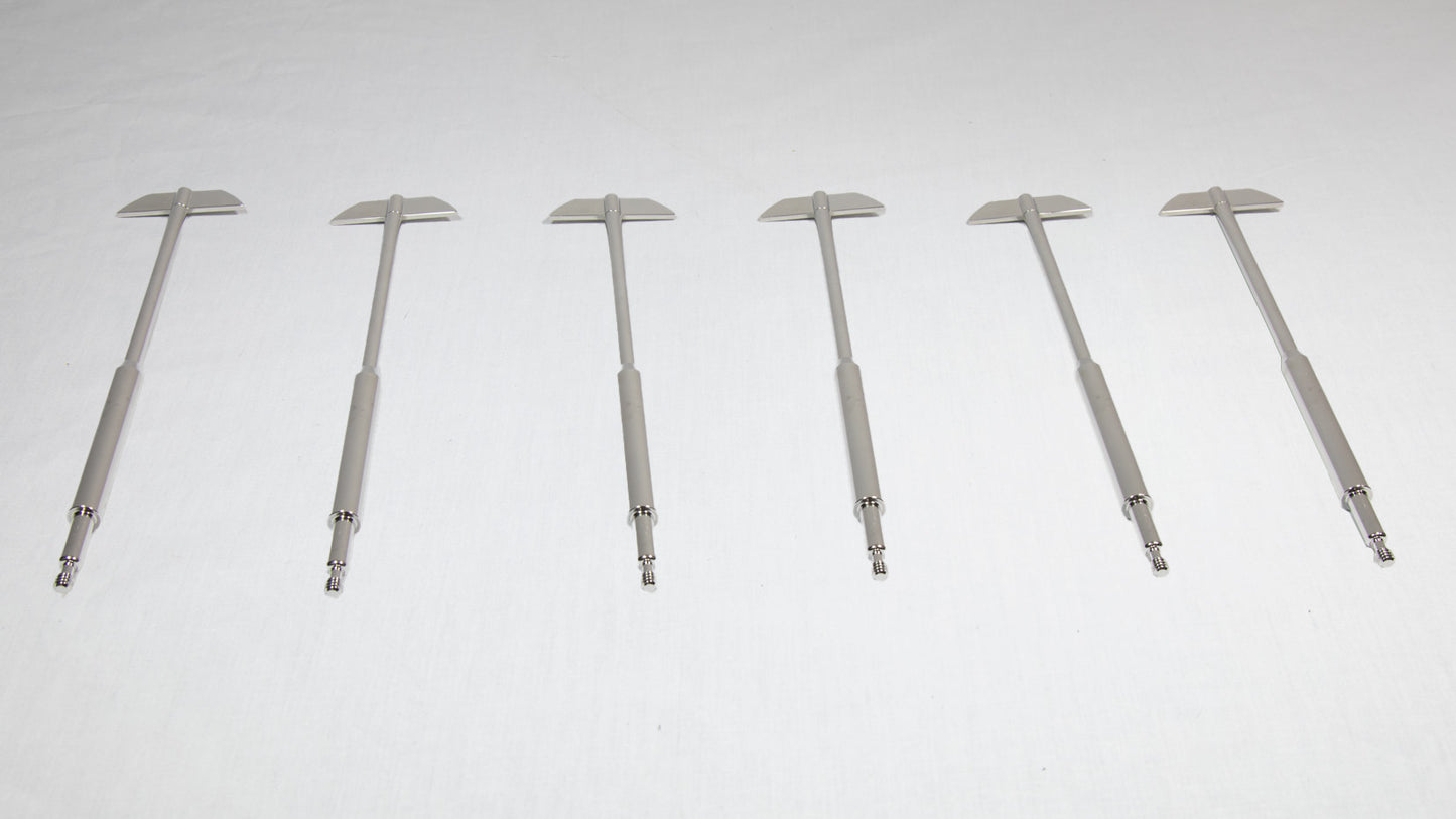Six uniquely shaped metal rods positioned together for comparison.