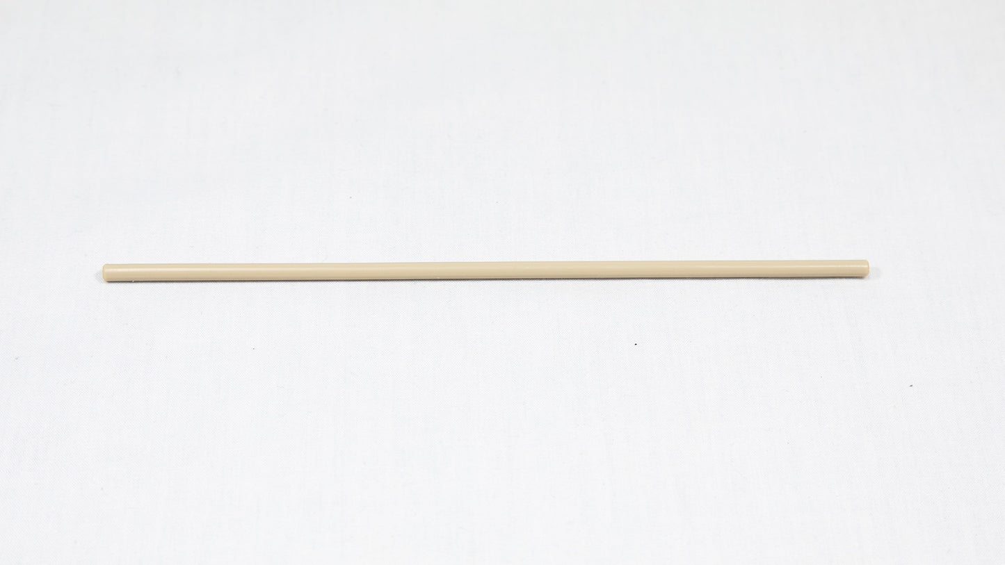 A long cylindrical shaped object pictured on a white background, creating a minimalist composition of everyday items.