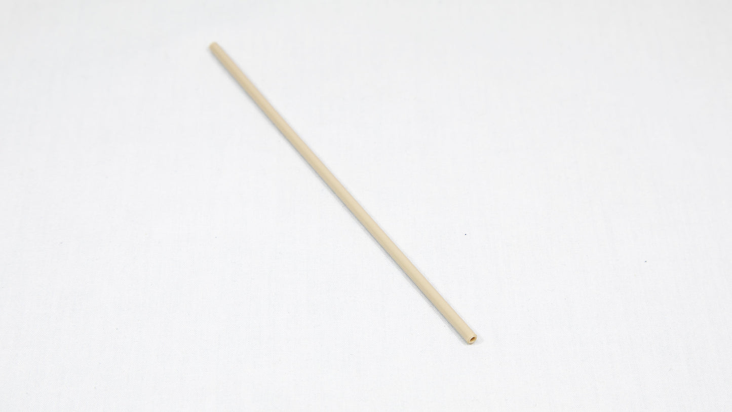 A long cylindrical shaped object pictured on a white background, creating a minimalist composition of everyday items.