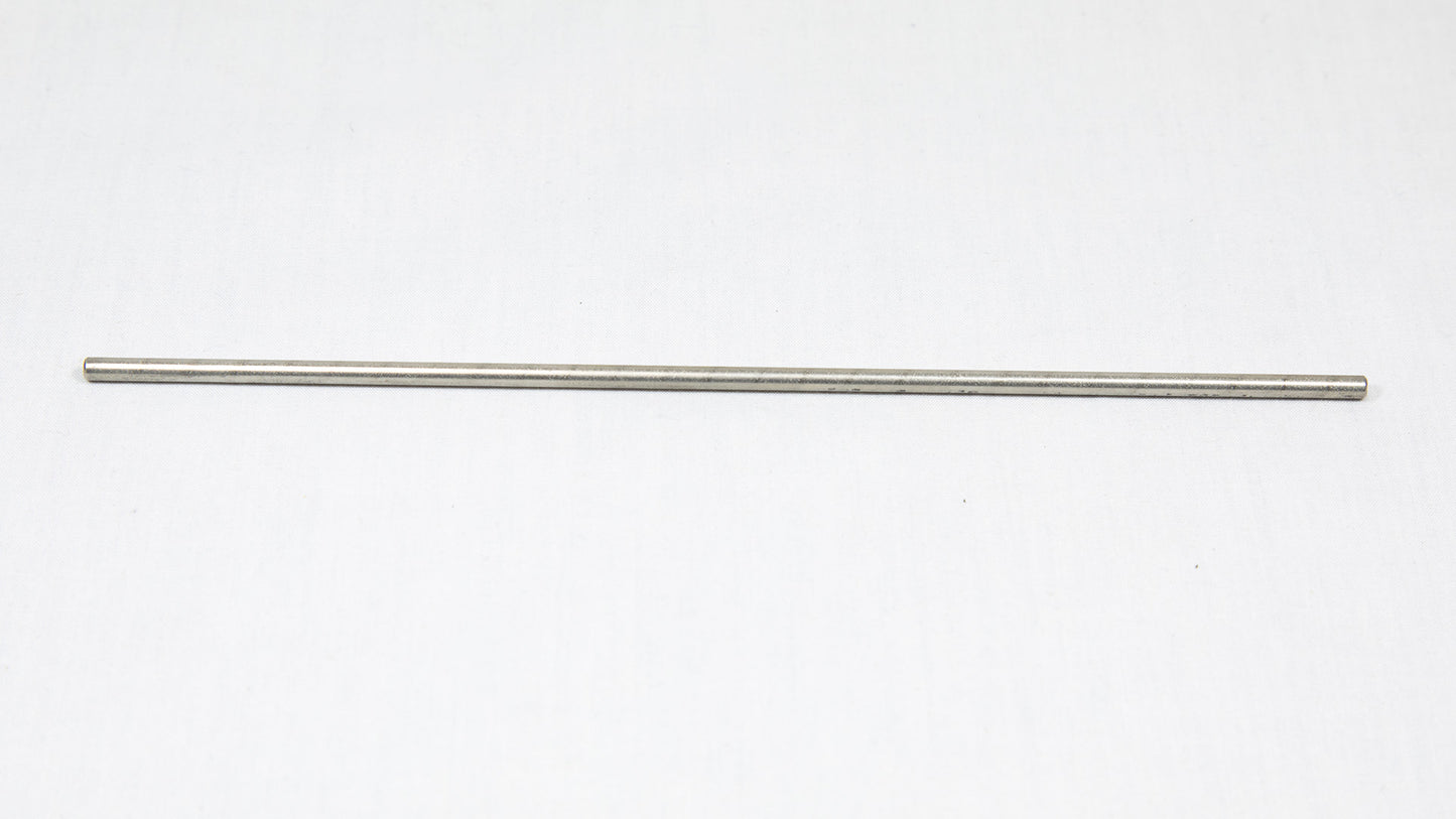 A long cylindrical shaped object pictured on a white background, creating a minimalist composition of everyday items.