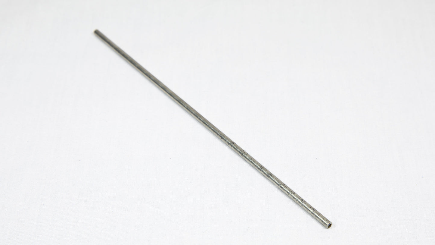 A long cylindrical shaped object pictured on a white background, creating a minimalist composition of everyday items.