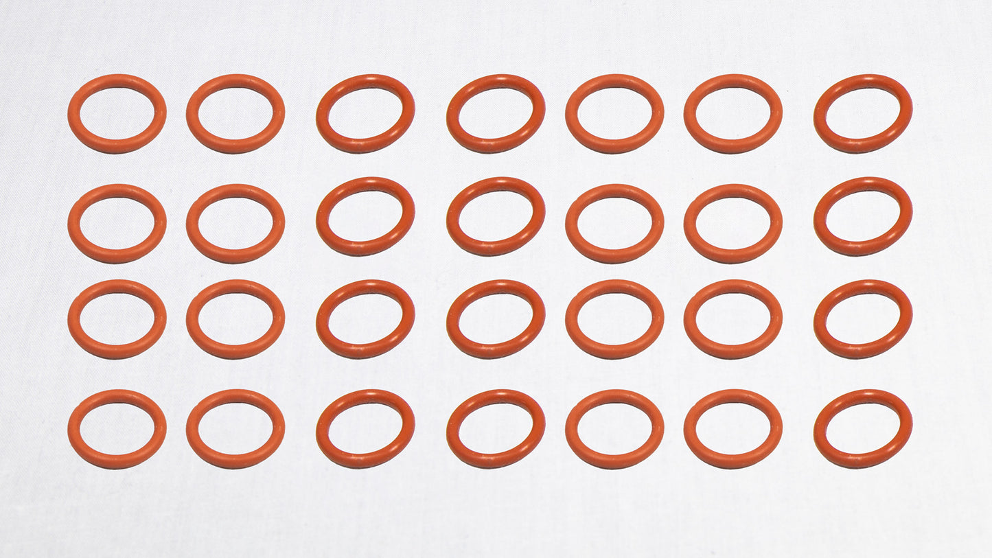 A group of orange rubber O-rings displayed on a plain white surface.