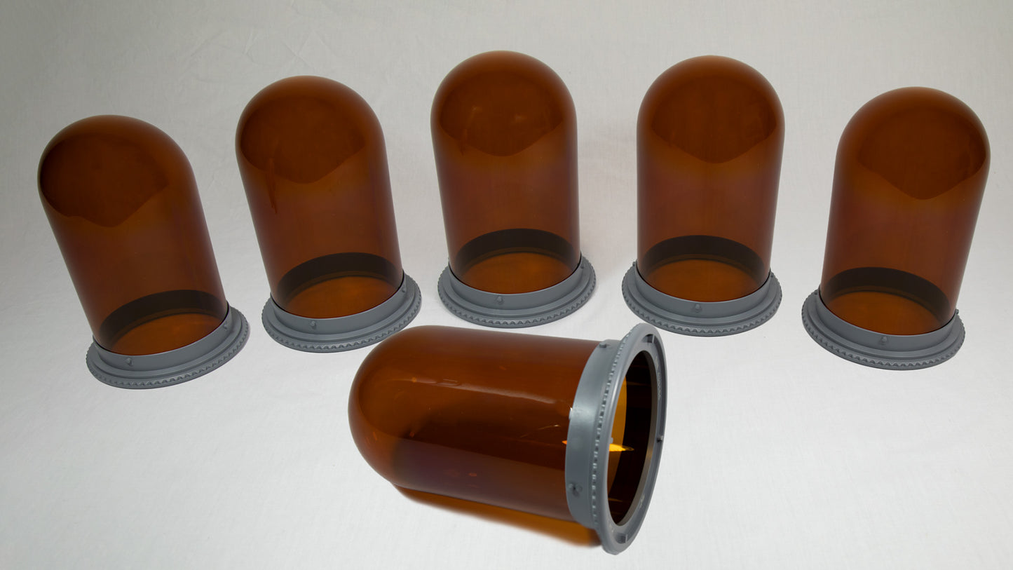 A collection of six amber colored vessels with sturdy bases.