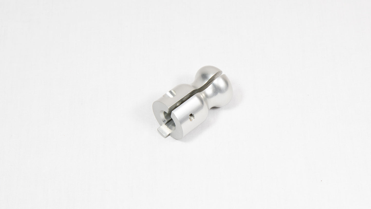A stainless steel metal object positioned on a bright white surface, highlighting its design and texture.