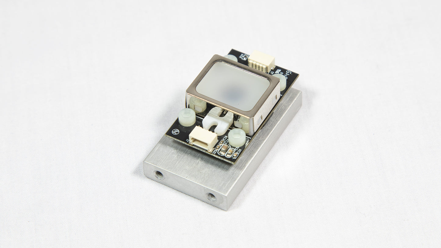 A small electronic device resting on a white surface, showcasing its compact design and modern features.