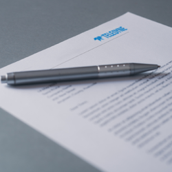 A pen lying on a contract, representing the final step in formalizing an agreement.