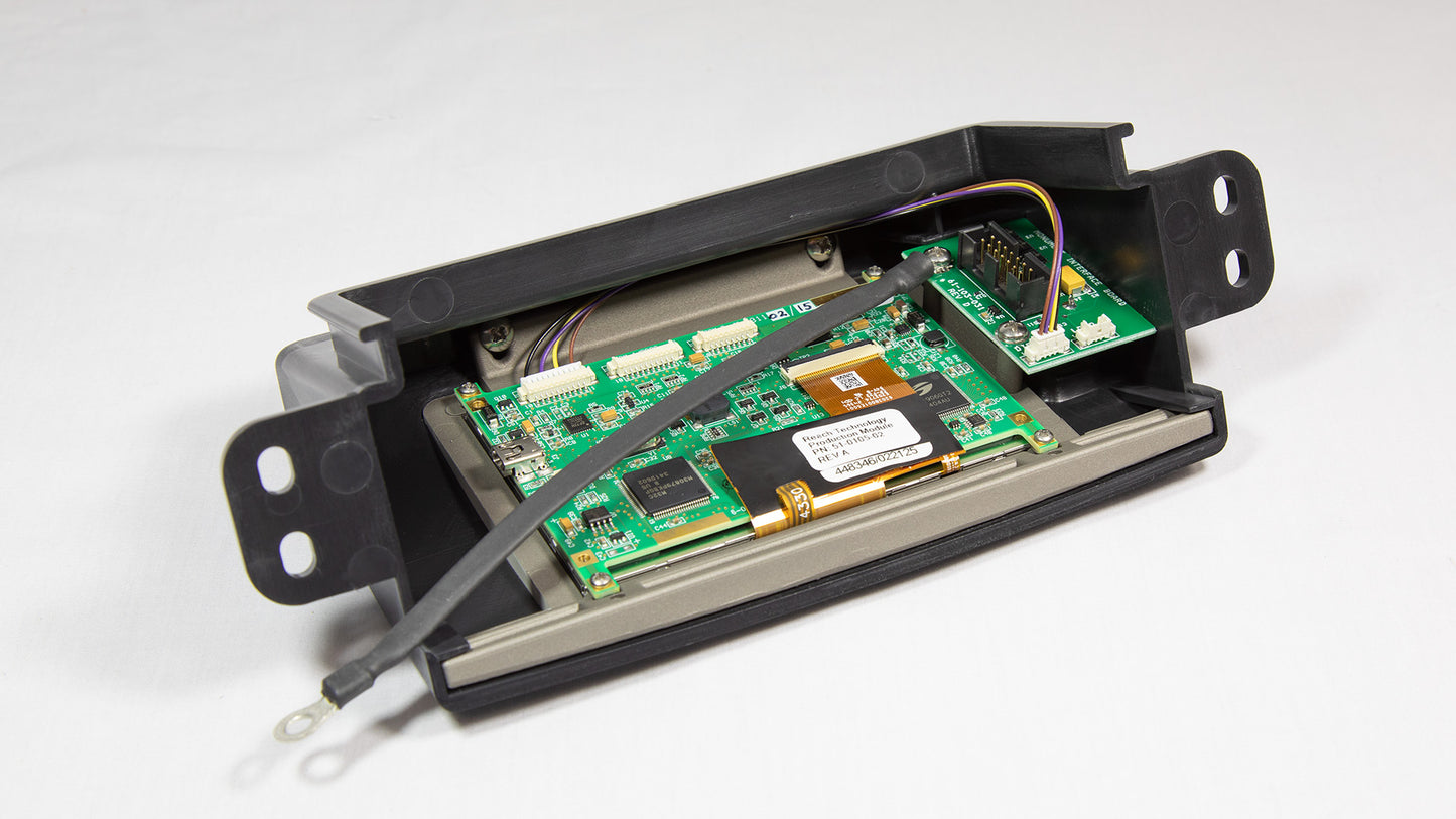 Compact electronic device with visible wires and a battery, used for powering or connecting electronic components.