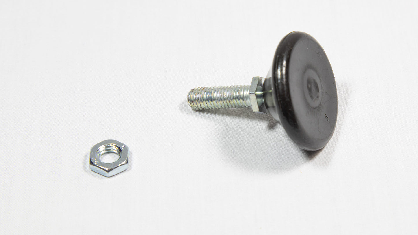 A nut and a threaded cylindrical shaped black object placed on a white surface, highlighting their contrasting colors.