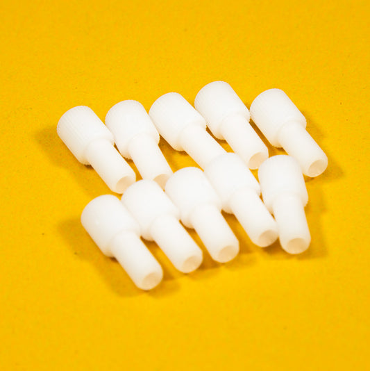 A collection of white plastic threaded fittings arranged on a bright yellow background.