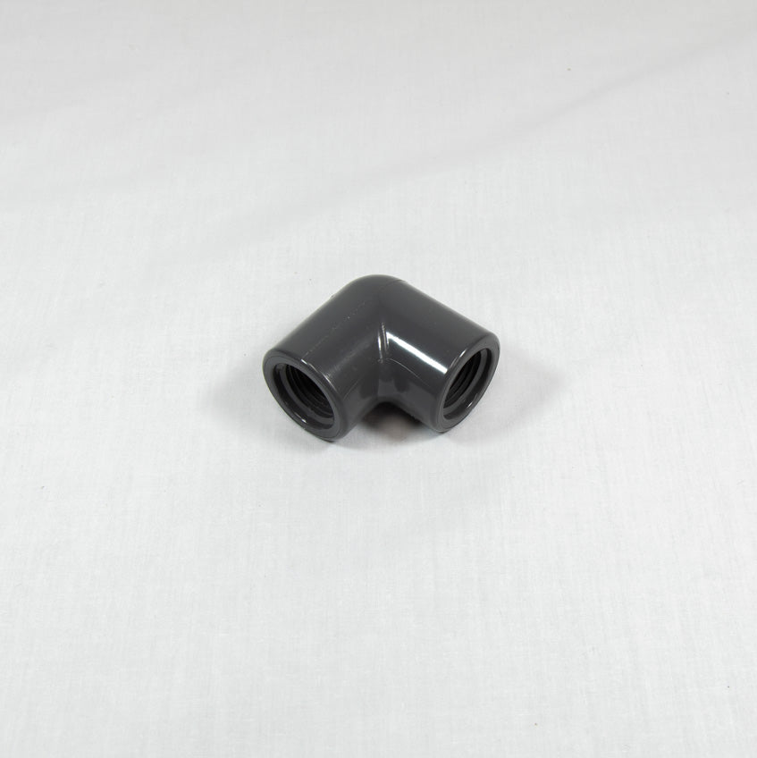 A grey plastic pipe fitting displayed against a white background, highlighting its shape and texture.