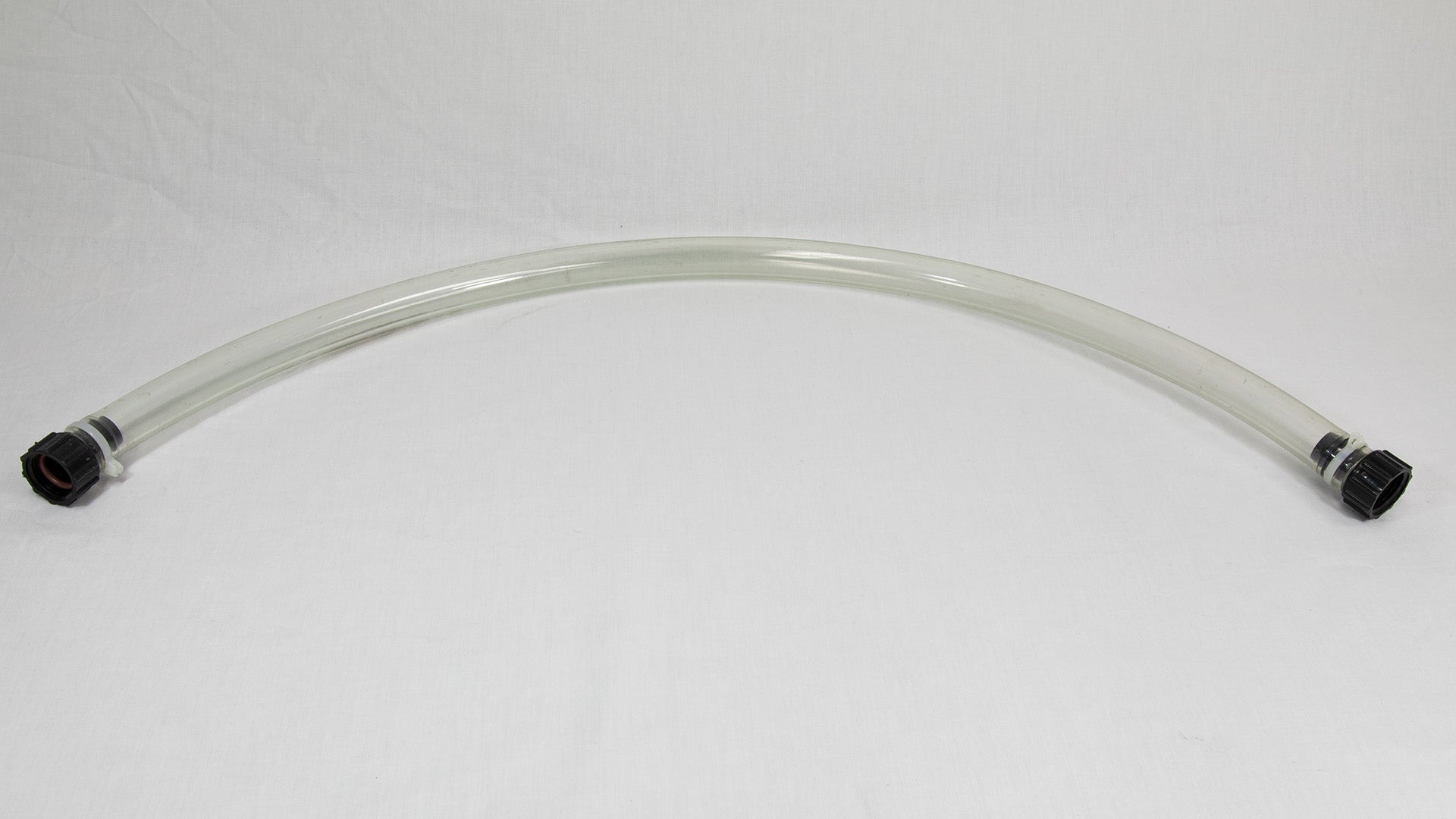 A piece of clear tubing with contrasting black fittings, isolated on a white background.