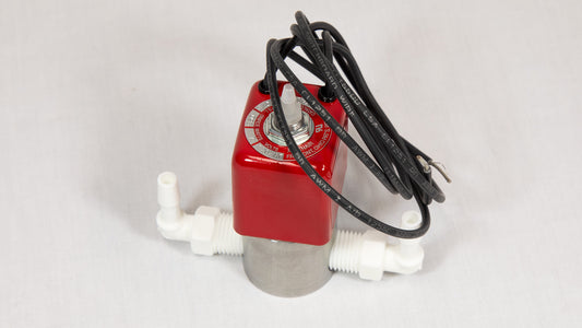 A red and white valve with a power wire attached, positioned against a neutral background.