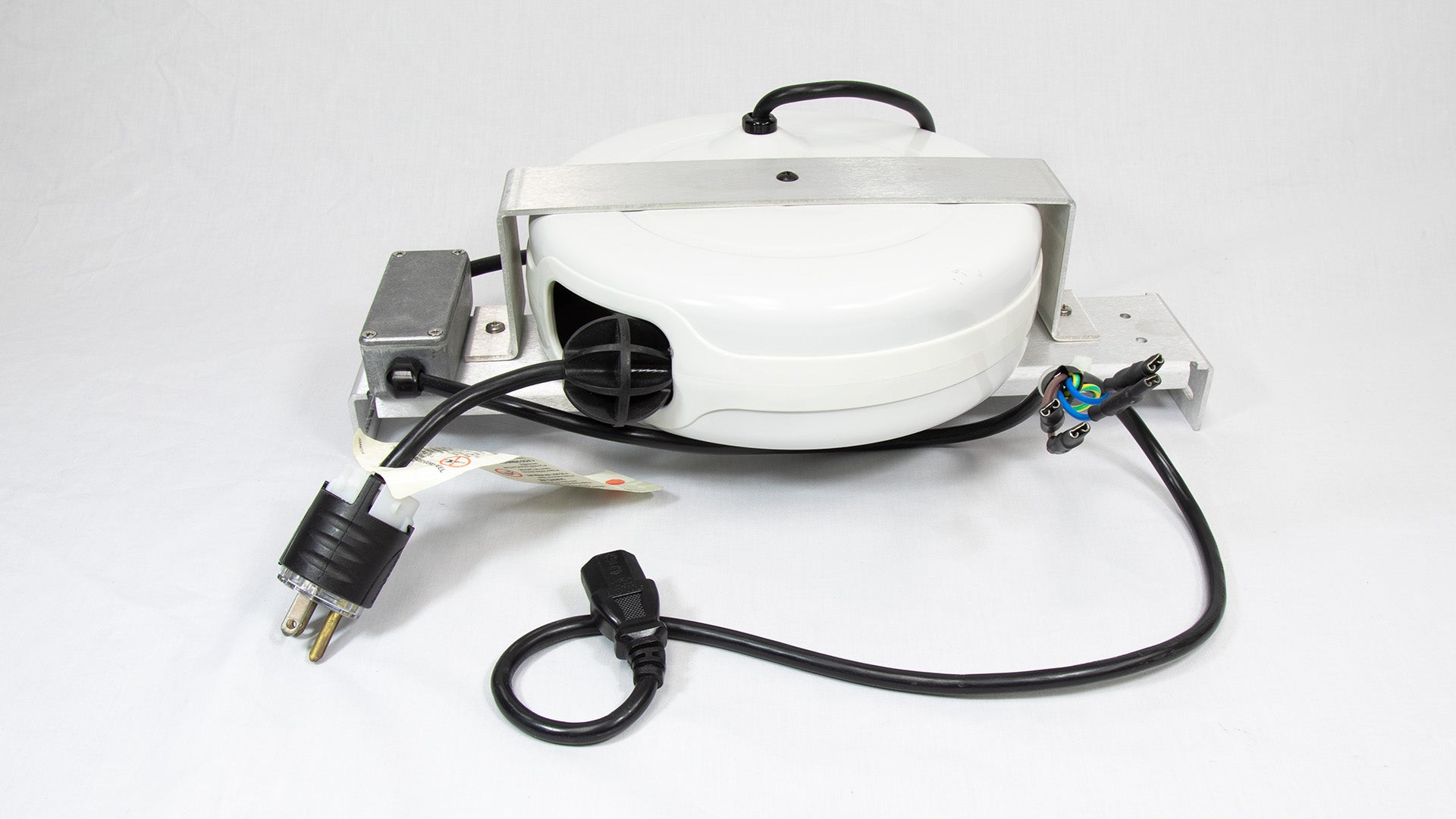 A circular white object with wires extending from it, indicating its function as an electronic component or device.