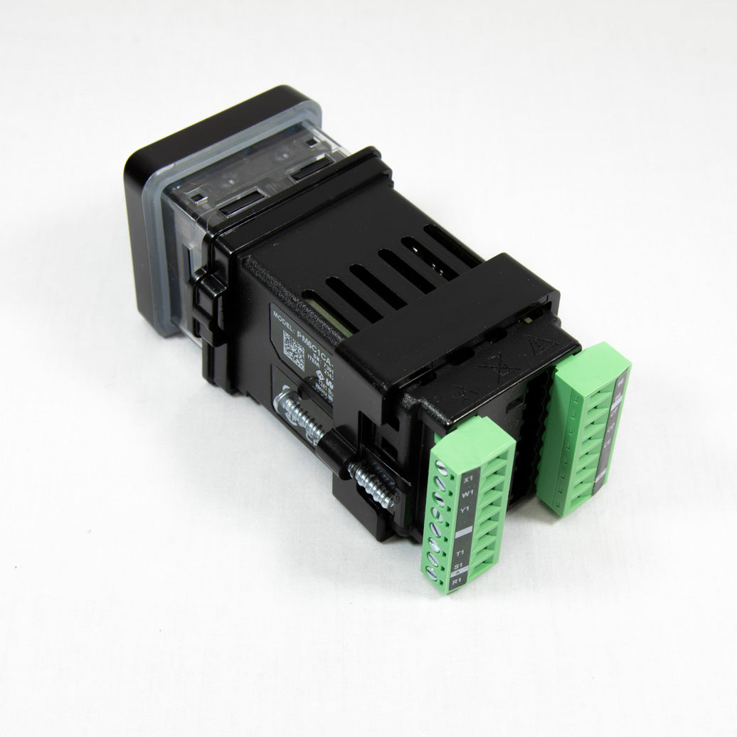 A small electronic device featuring a green and black cover, positioned on a neutral background.
