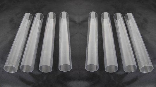 Eight clear plastic tubes of varying sizes arranged together on a neutral background.