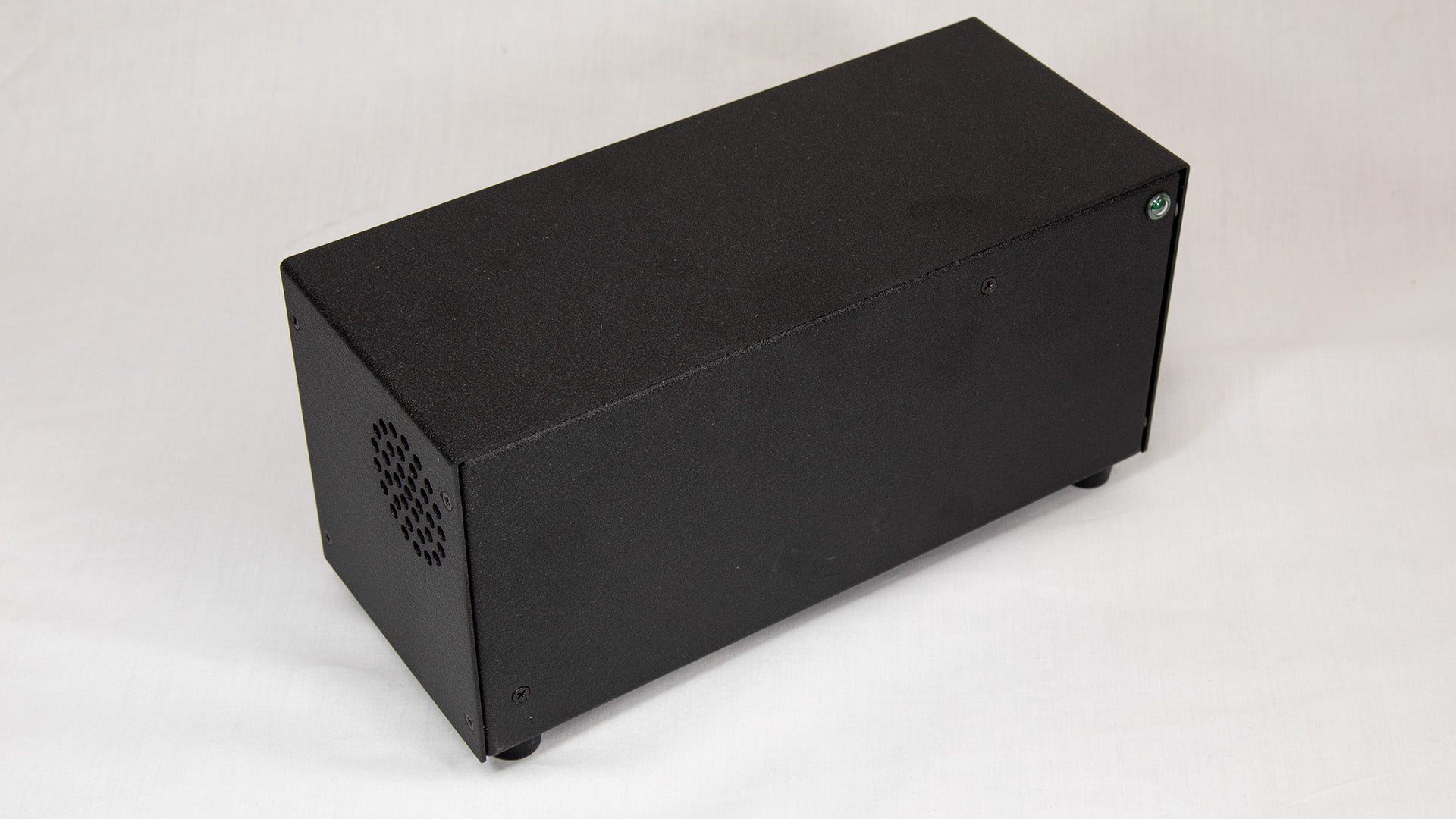 A black box featuring holes for dissipating heat.