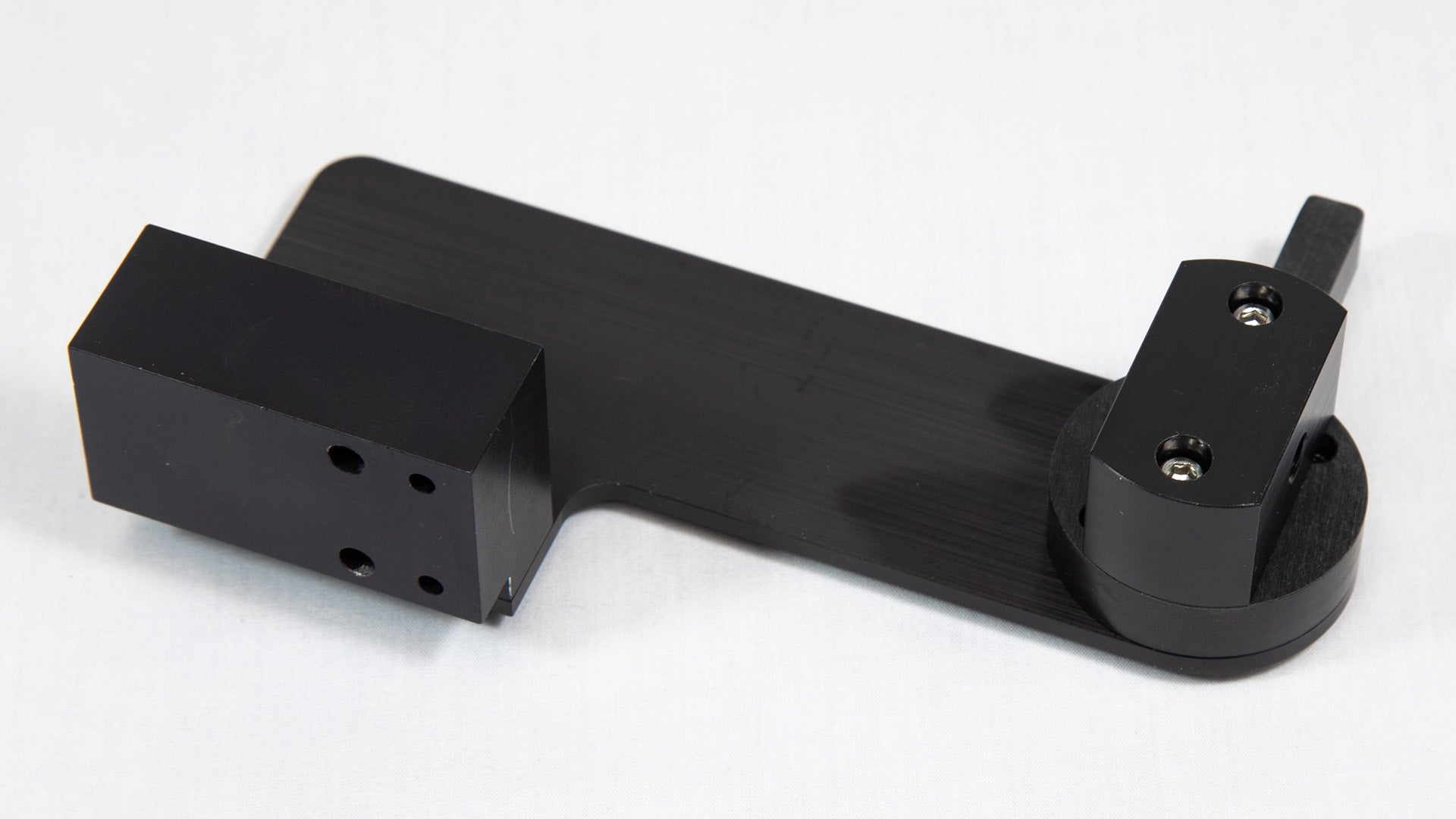 A black object, likely designed for a specific use or to connect with other components.