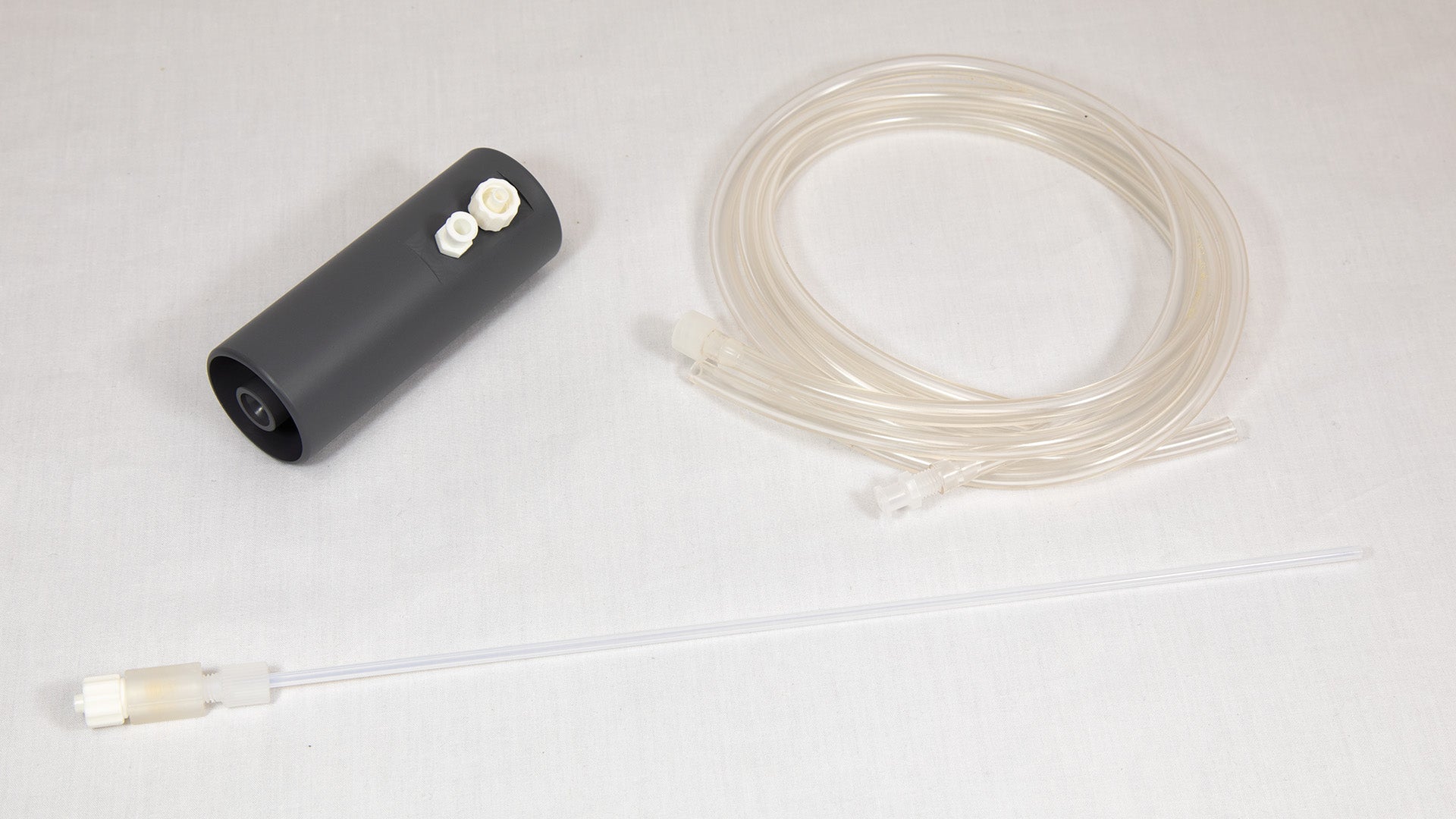 A small plastic apparatus with a hose and tube attachment, intended for fluid or air movement.
