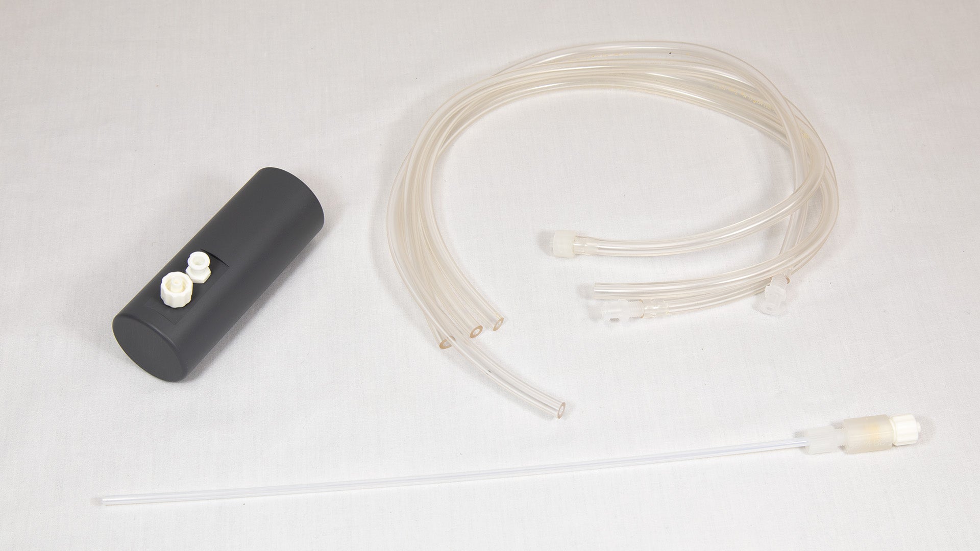 A small plastic apparatus with a hose and tube attachment, intended for fluid or air movement.