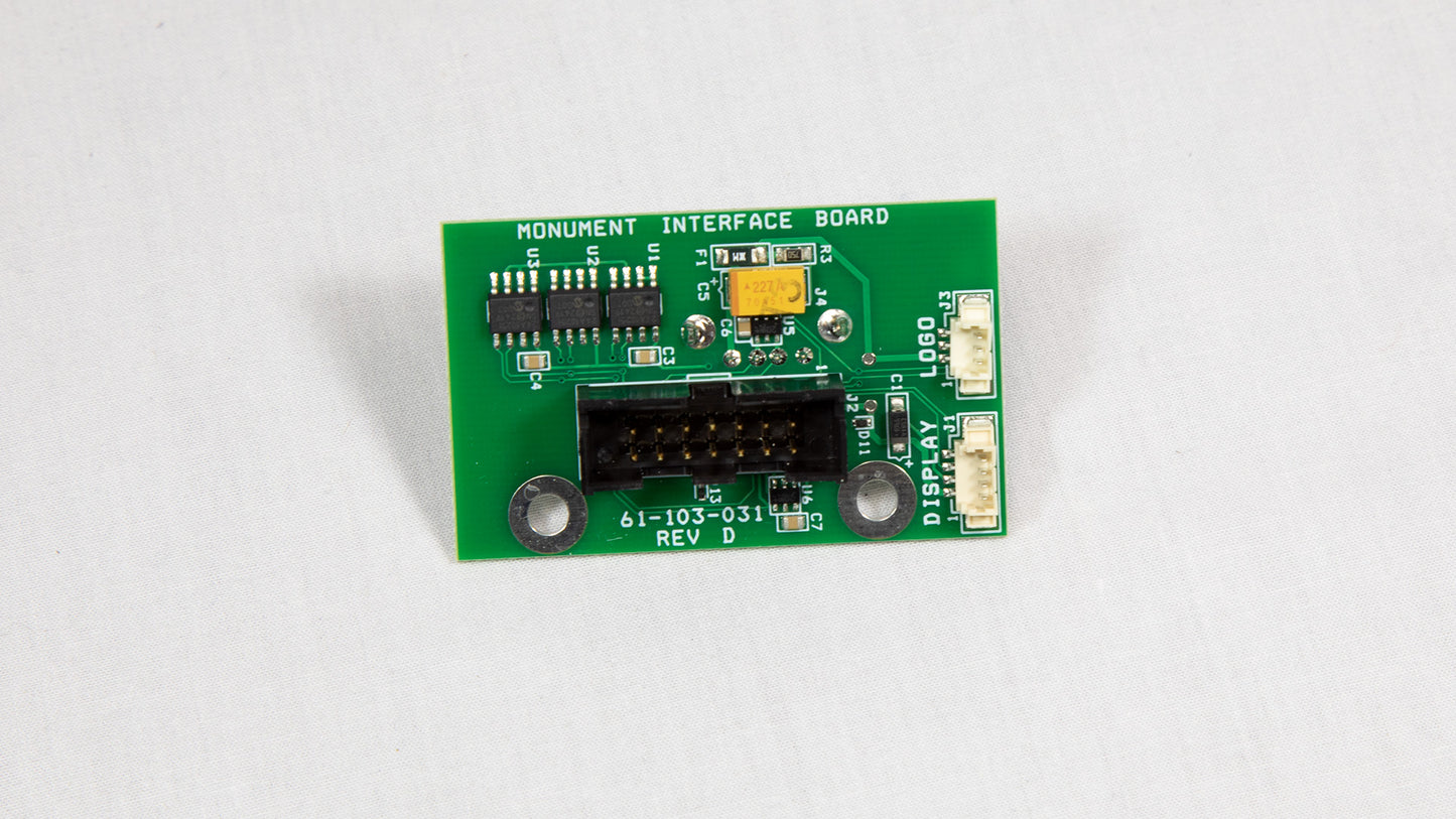 A green electronic circuit board with various components displayed on top.