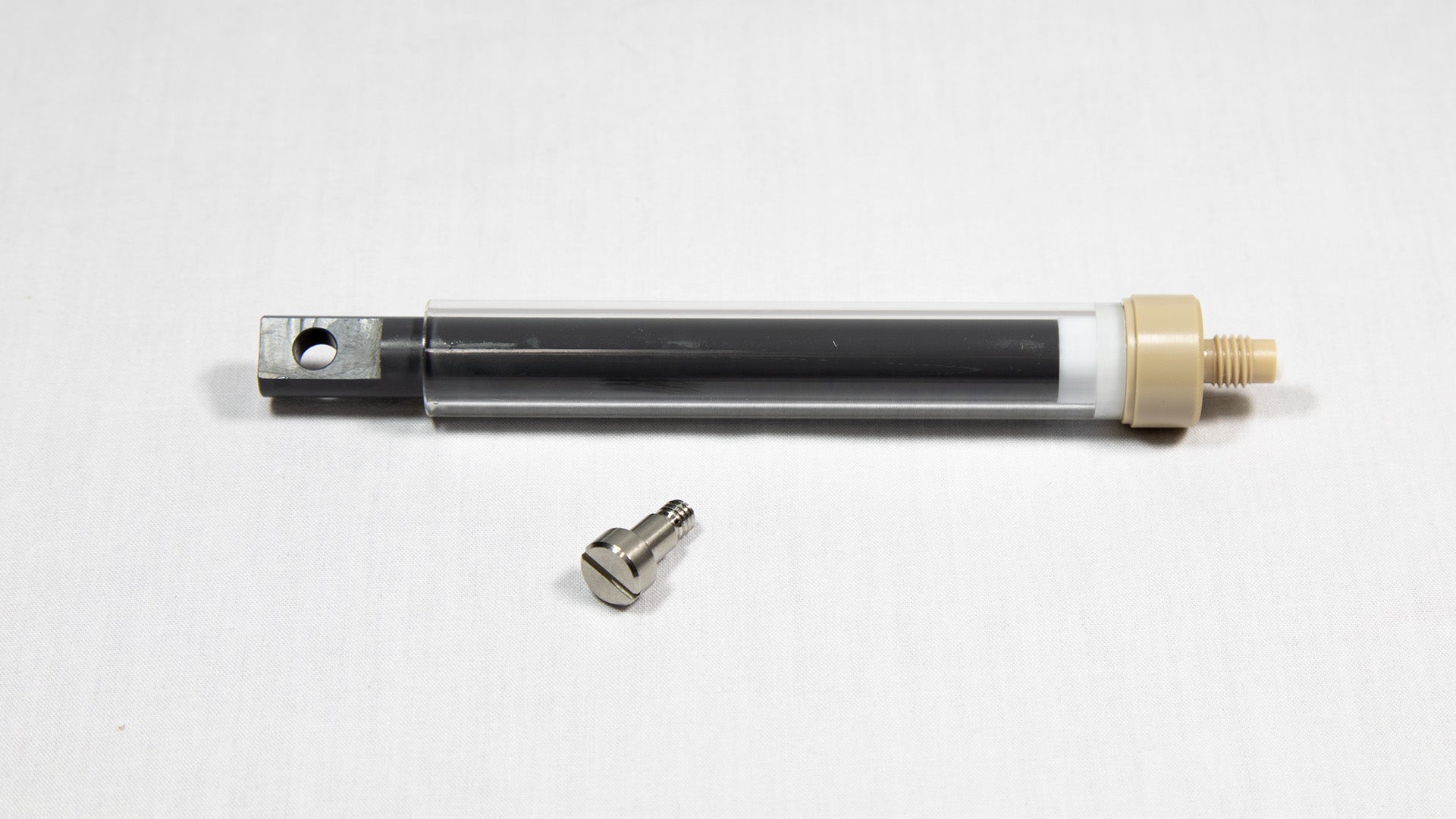 A clear plastic syringe featuring a screw, highlighting its intricate design.