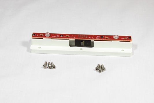 A white electronic device featuring visible screws and a sleek design, positioned on a neutral background.