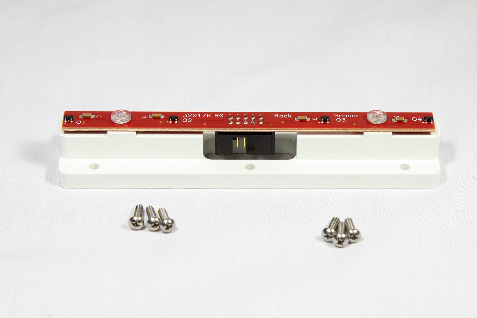 A white electronic device featuring visible screws and a sleek design, positioned on a neutral background.