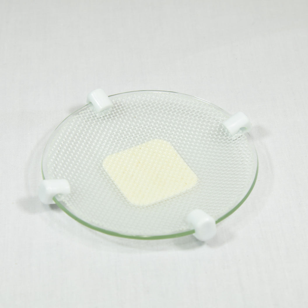 A transparent plate with a white patch, highlighting a neat and organized appearance.