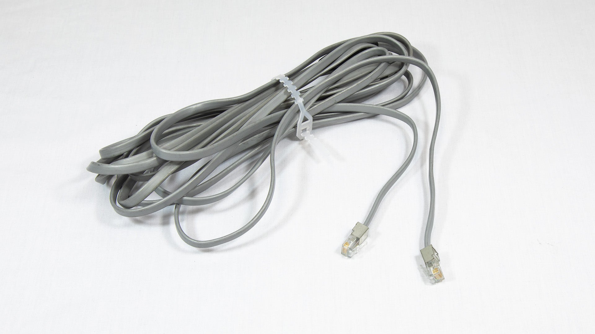 A grey cable with connectors, representing a typical element found in various communication connections.