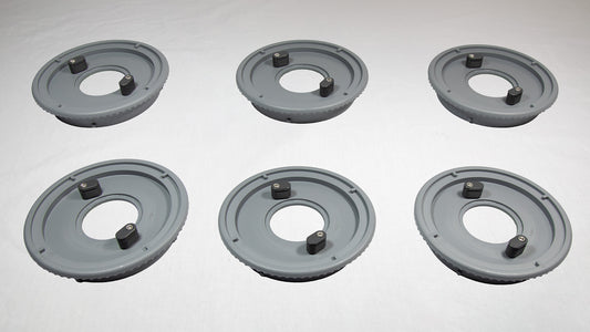 Six gray plastic plates with holes and screws, organized in a row, showcasing their design and functionality.