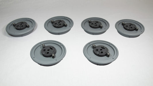 A collection of six gray plastic plates, each with holes and screws, displayed together on a plain background.