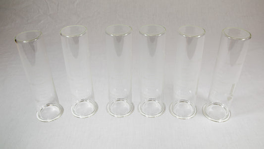 Six clear plastic containers with lids arranged neatly on a bright yellow background.